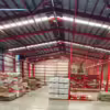 Large metal warehouse with stacks of large bags of coffee in Guatemala